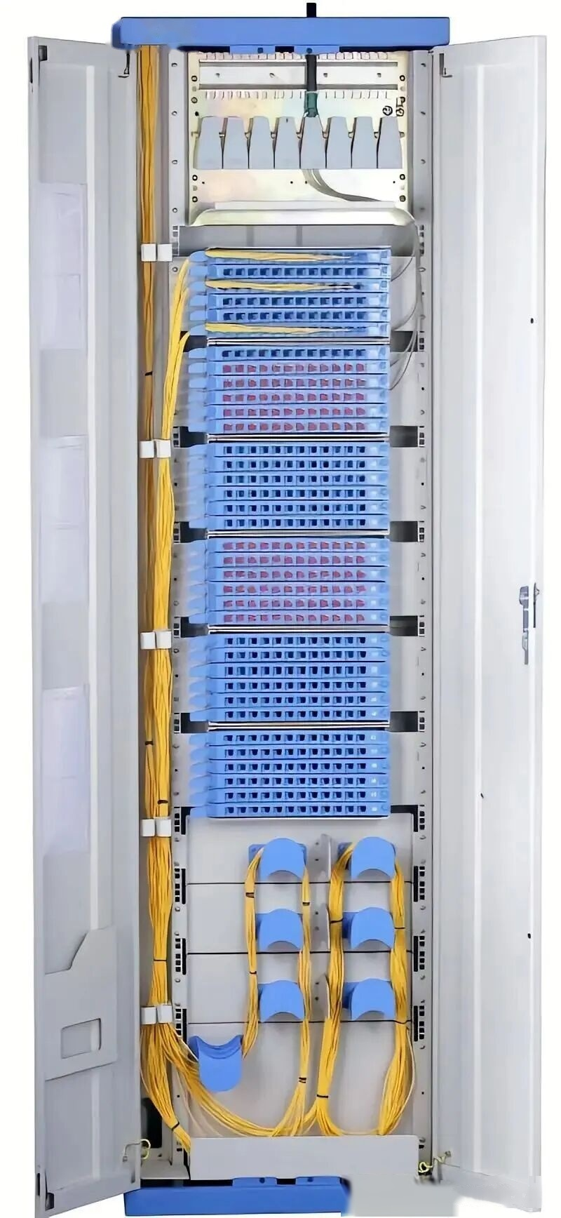 Installed ODF cabinet in a real equipment room with labeled blue adapter panels, yellow single-mode patch cords, and slack spools